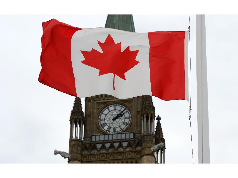 a-canadian-flag-blows-in-front-of-the-peace-tower_thumb-1.jpg